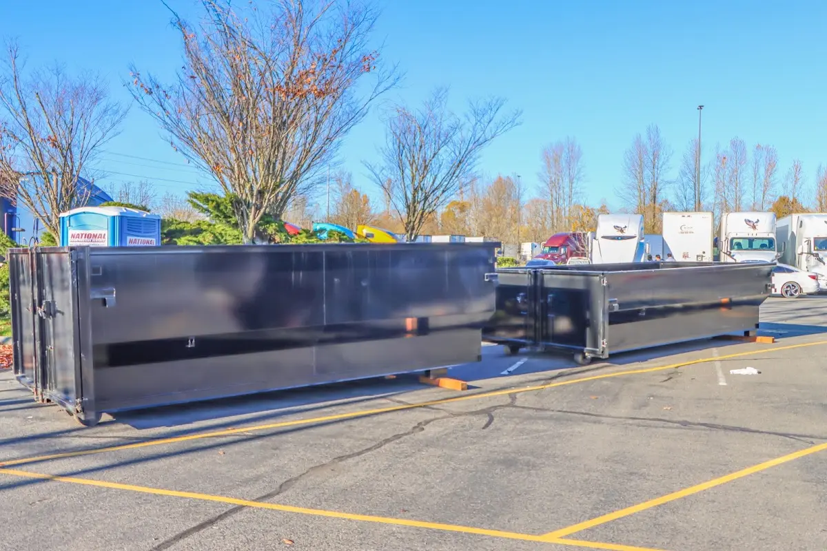 Professional dumpster rental service with roll-off container on residential driveway in Salida